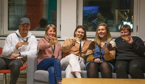 Five students holding up their creations