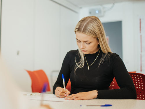 A student is writing. 