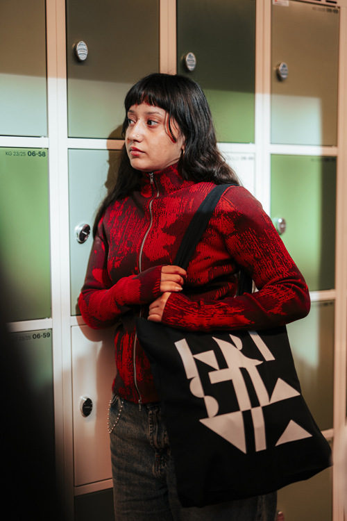 Student standing in front of the lockers in Kirkegata