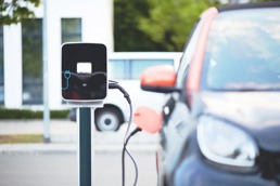 Electric car charging at a charging station.