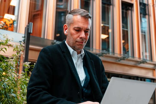 Man with computer, studying outside