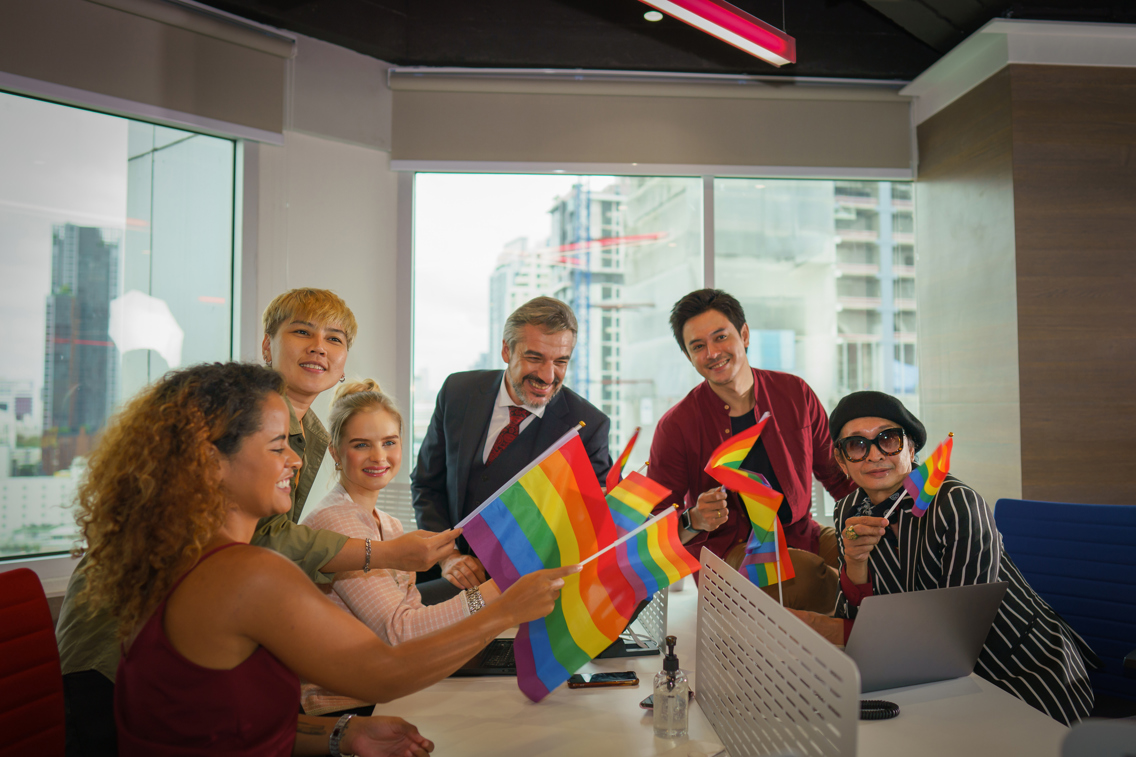 En gruppe mennesker med pride-flagg på jobb