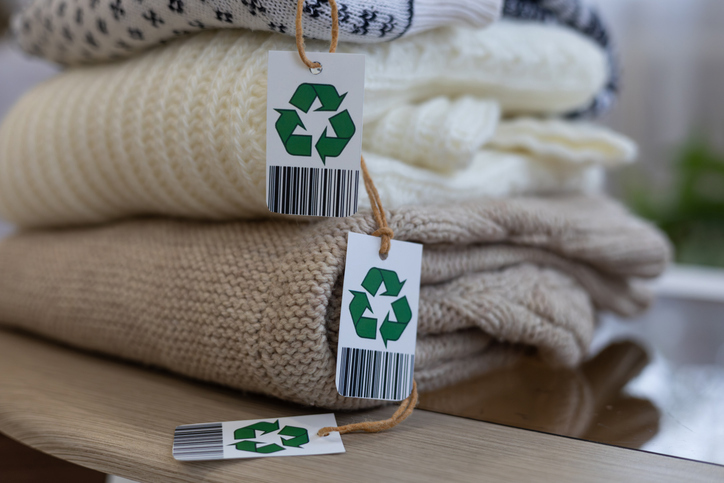 Folded clothes with eco-certification tags.